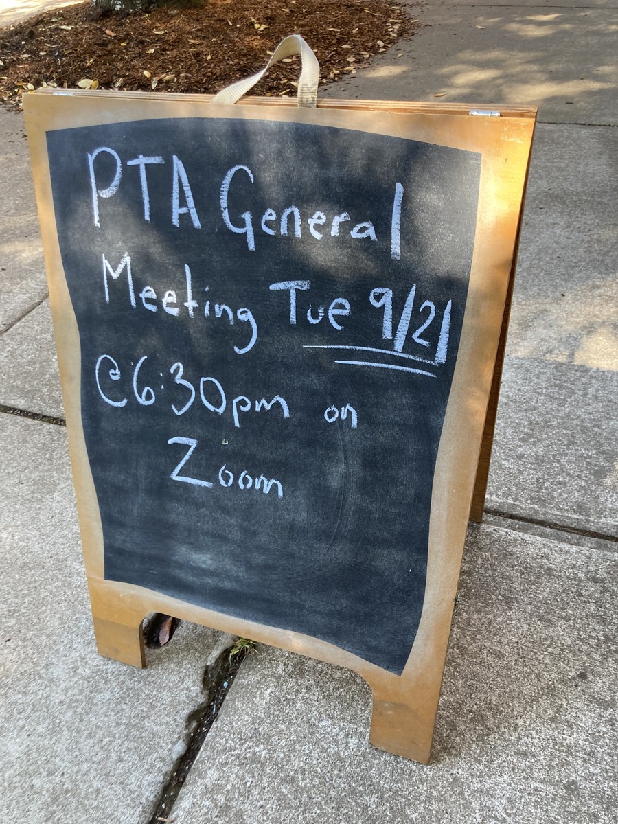 Breadboard announcing a PTA meeting Breadboard on a sidewalk, reads: “PTA General Meeting Tue 9/21 @6:30pm on Zoom”