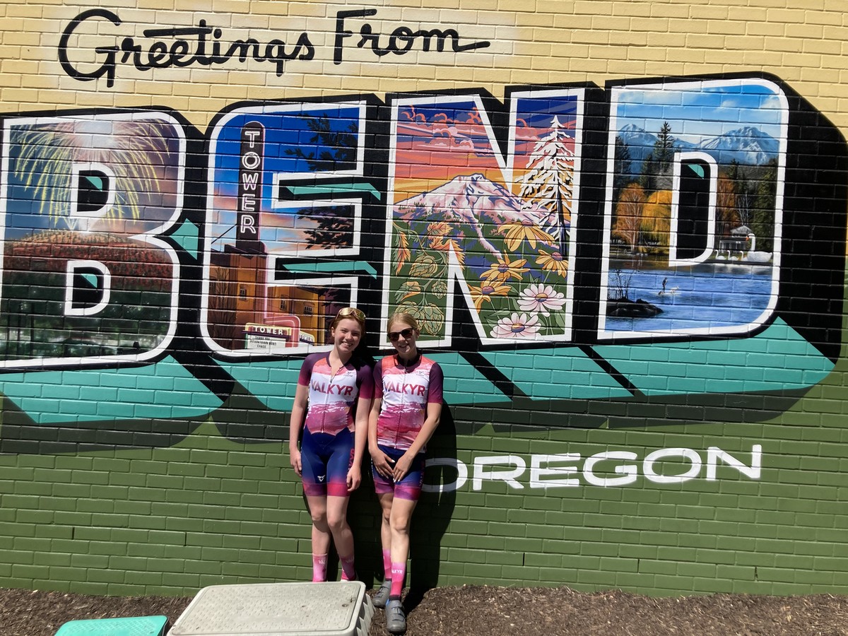 Two VALKYR juniors in front of a mural reading Greetings from BEND Oregon Two VALKYR juniors in front of a mural reading Greetings from BEND Oregon
